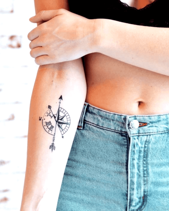 Compass Arrow Tattoo on girl's arm