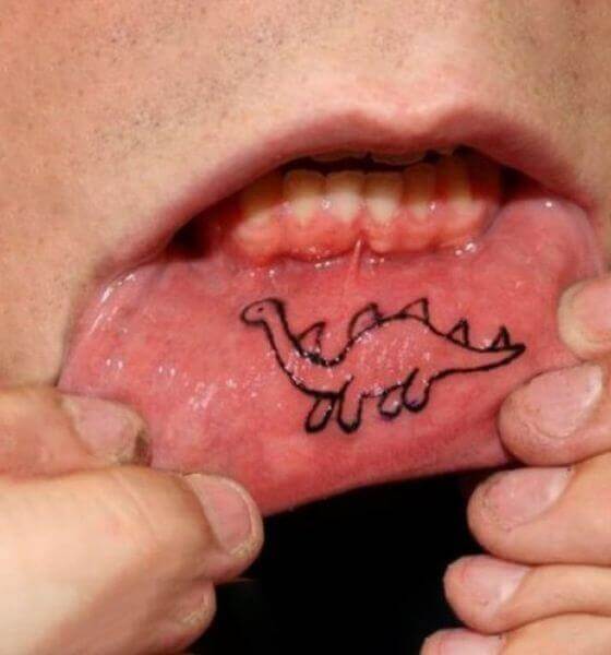 Dinosaur tattoo on the Girl's inner lip