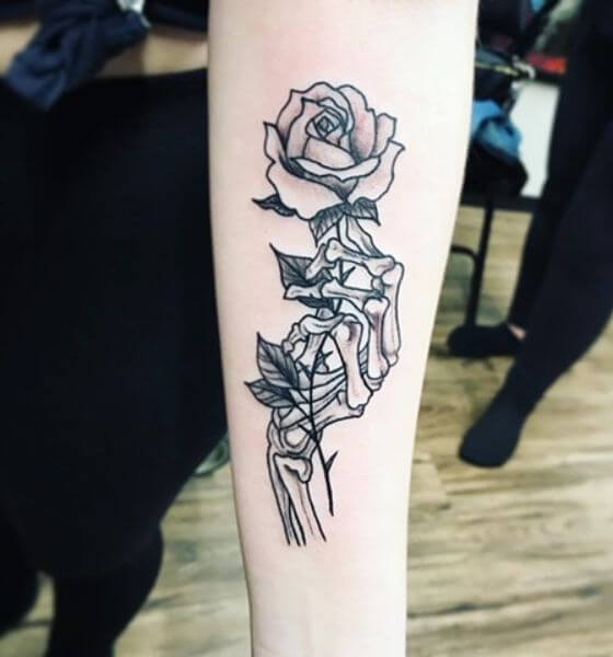 Premium Vector  A skeleton hand holding a flower rose and hand tattoo style