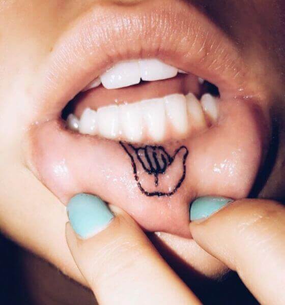 Hand symbol lips tattoo