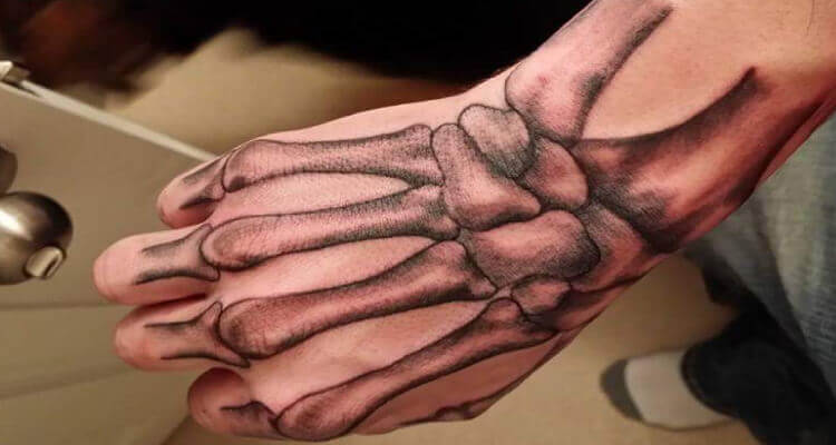 1. Skeleton Hand Tattoo Designs - wide 8