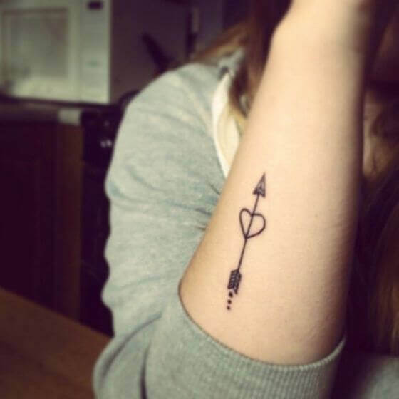 Small Heart and Arrow Tattoo on women forearm