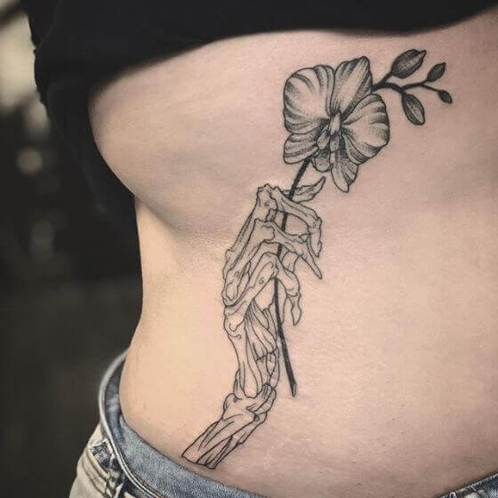 best Skeleton Hand with Flowers Tattoo