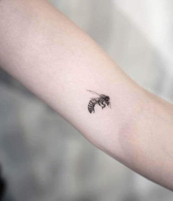 Tiny Honey bee tattoo on the arm