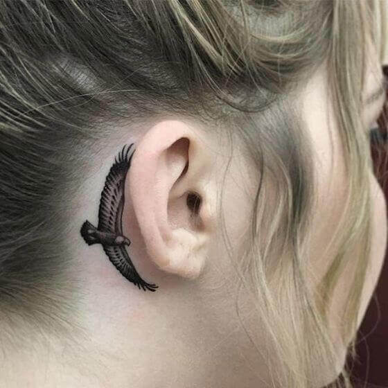 Small Eagle tattoo on behind the ear