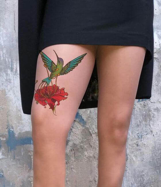 Hummingbird Tattoo with flower On girl Thigh