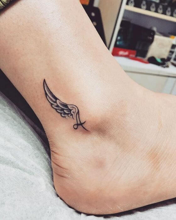 Initial Ankle Tattoo with Small Wing 