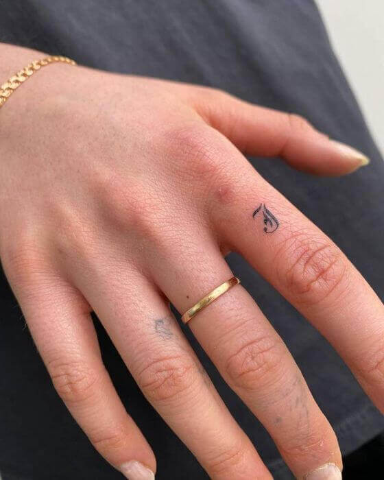 Initial Tattoo on finger 
