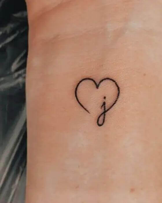 Initial Tattoo with Love symbol on the wrist 