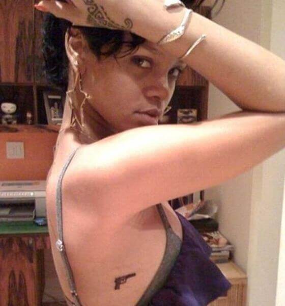 Gun on her ribcage - Rihanna tattoo