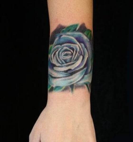 Blue rose tattoo on arm