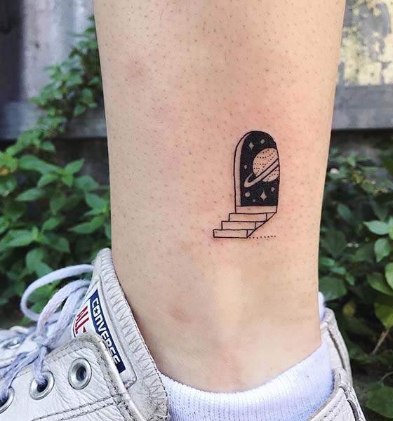 Creative space tattoo on leg