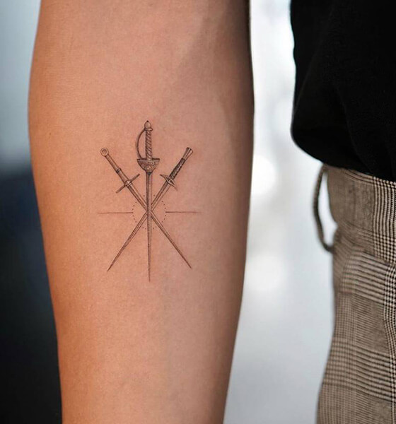 Crossed Swords Tattoo on Inner Arm
