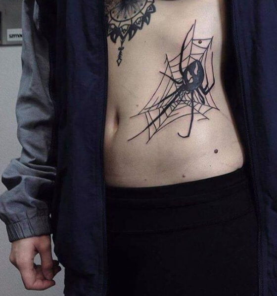 Spider tattoo on rib cage