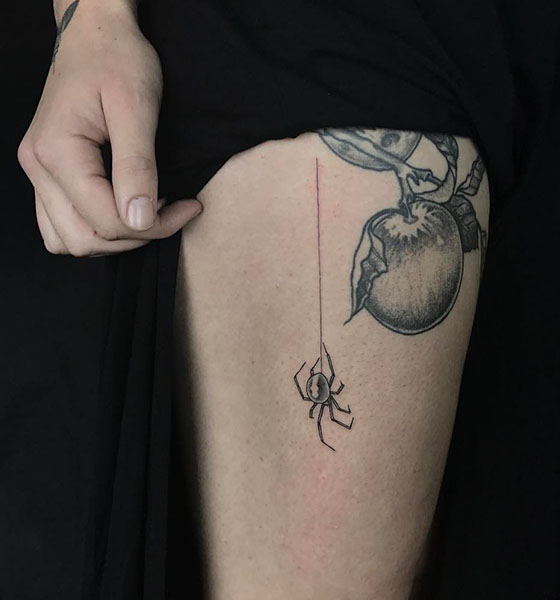 Spider tattoo on thigh