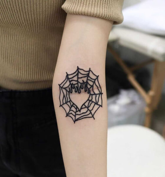 spider web tattoo on elbow