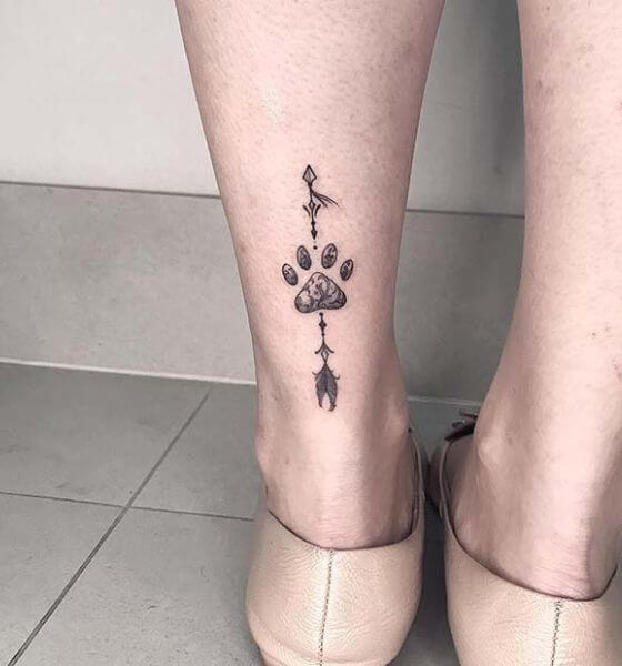 Elegant Paw with Arrow Tattoo on Leg