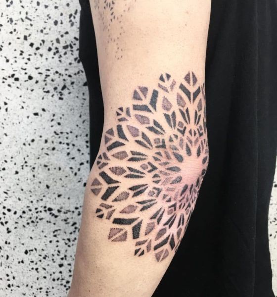 Geometric flower tattoo on elbow