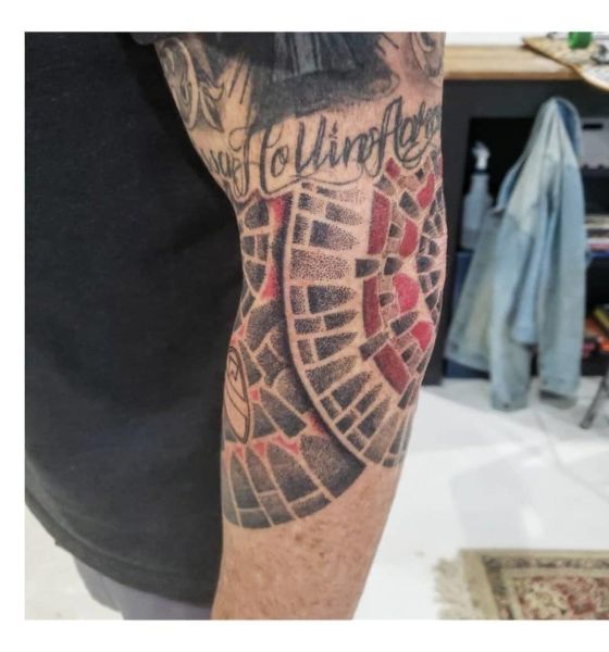 Geometric tattoo design on elbow