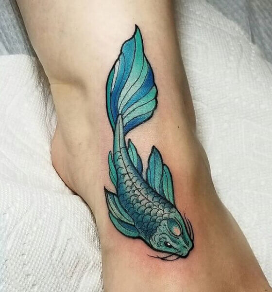 Green koi fish tattoo on foot