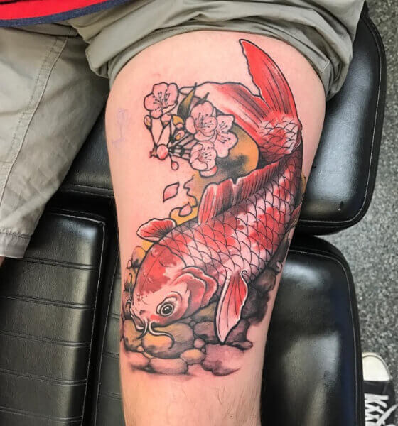 Koi fish with flower tattoo on thigh