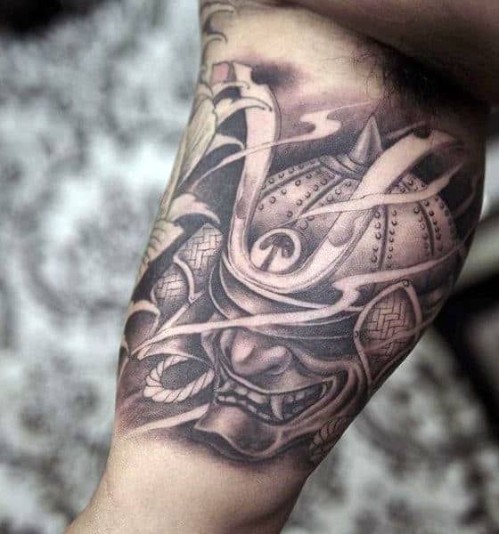 Samurai mask tattoo on bicep