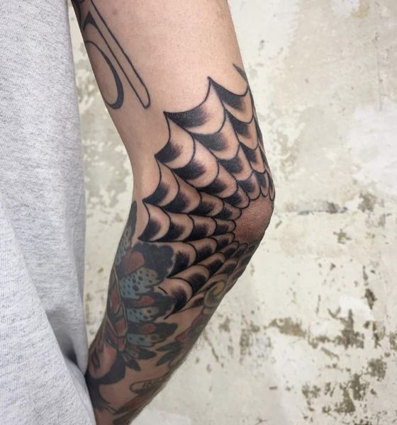 Spider web tattoo on elbow