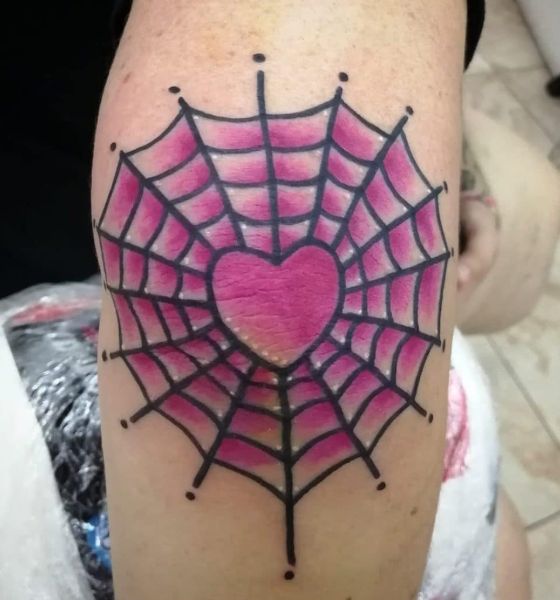 Spider web with heart tattoo on elbow