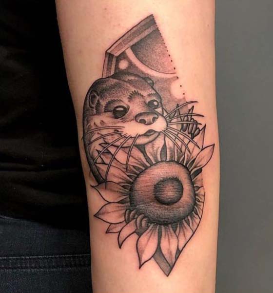 Sunflower with dog tattoo on elbow