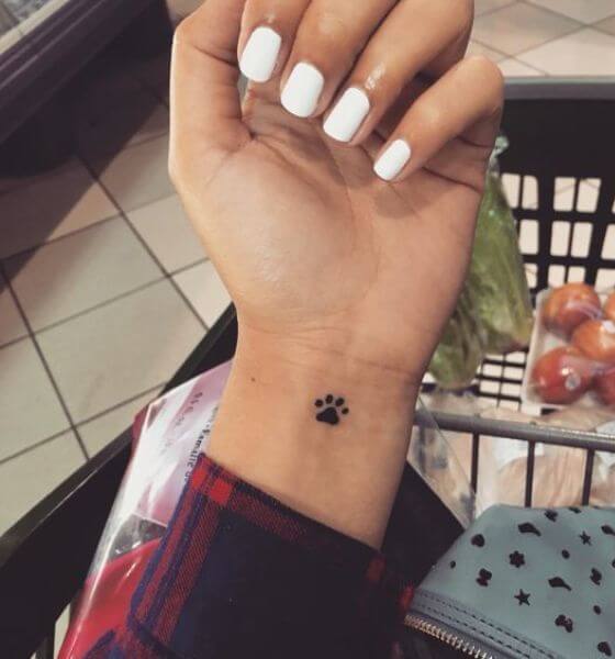 Tiny paw tattoo on wrist