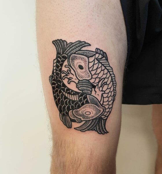 Two koi fish tattoo designs on thigh