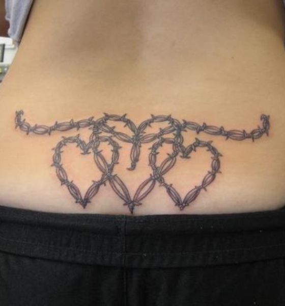 A young woman with a Sacred Heart tattoo on her back visits an outdoor art  show in Santa Fe New Mexico Stock Photo  Alamy