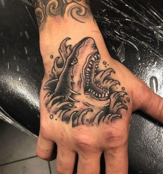 Pain shark tattoo on hand