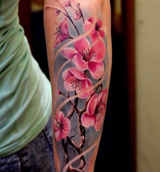 Realistic cherry blossom tattoo on arm