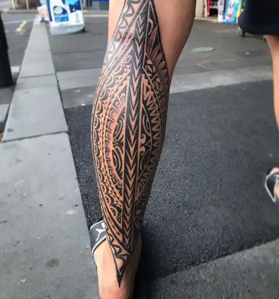 Black ink tattoo on calf leg for guys