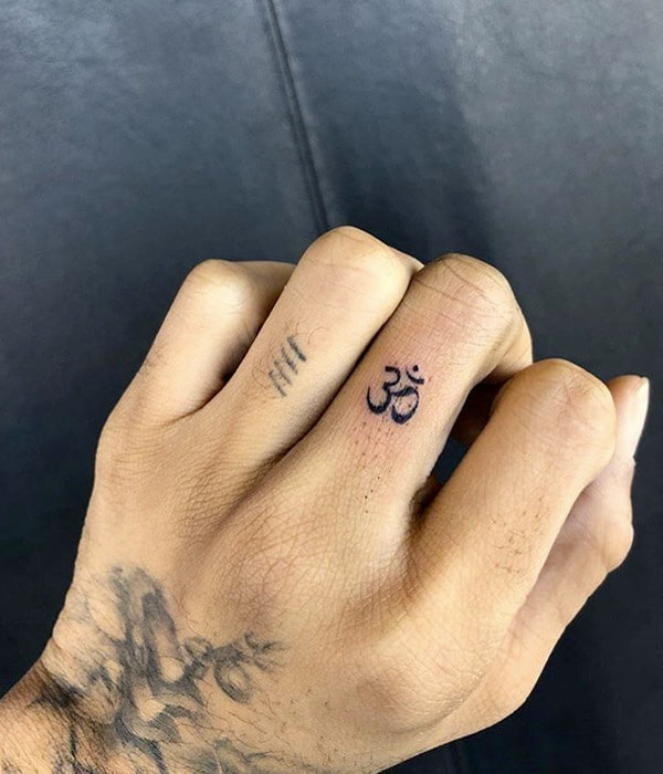 Tiny Om Symbol Tattoo on Finger