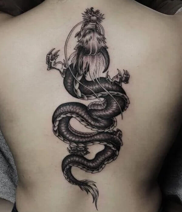 Fine line snake tattoo on the back