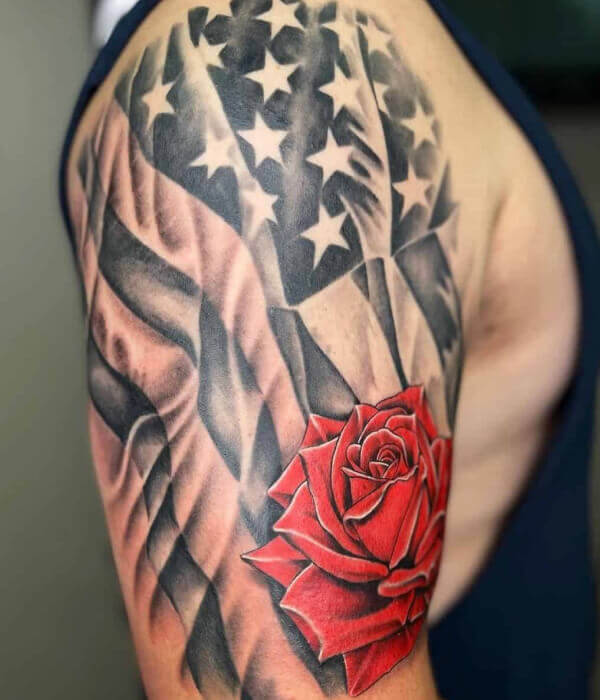 Shoulder American flag tattoo with a rose