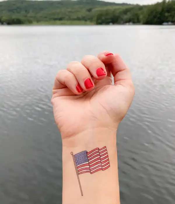 Small American flag tattoo on wrist