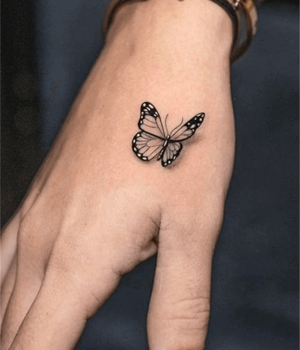 A simple black butterfly hand tattoo