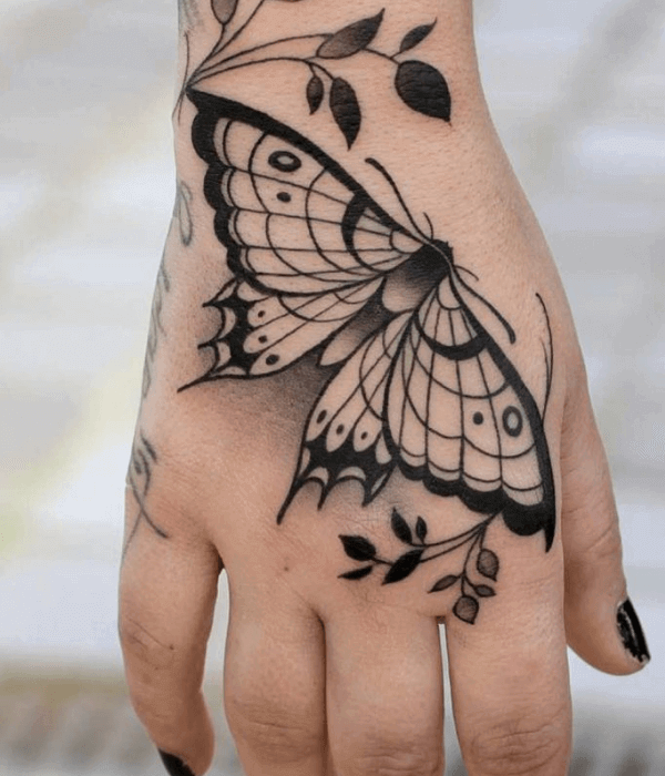 A simple black butterfly hand tattoo