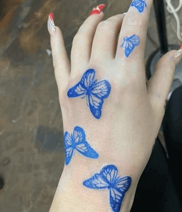Blue butterfly hand tattoo