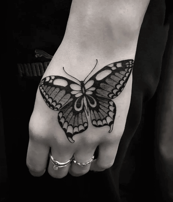 Dramatic black and grey butterfly hand tattoo