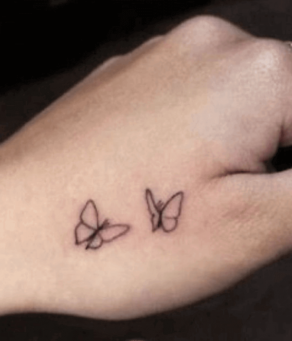 Minimal butterfly hand tattoo