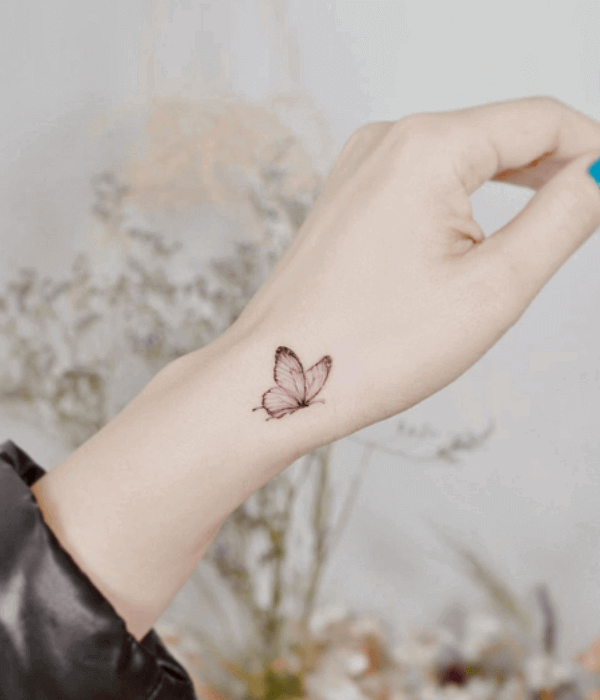 Minimal butterfly hand tattoo