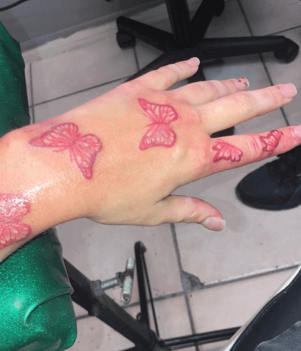 Red butterflies hand and finger tattoos