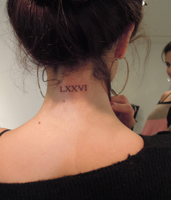 Roman numerical tattoo on the back of the neck