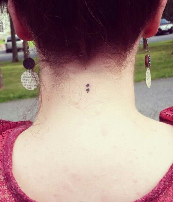Semicolon back of the neck tattoo