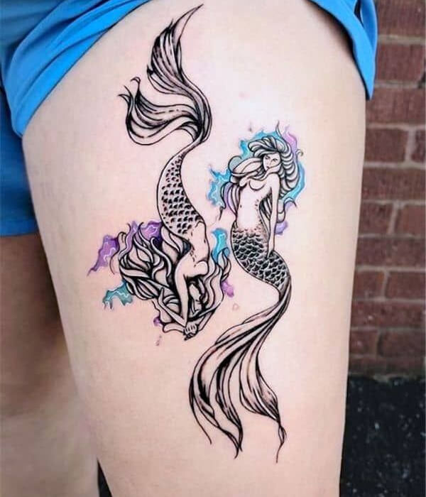 A dual mermaid thigh tattoo for Pisces females