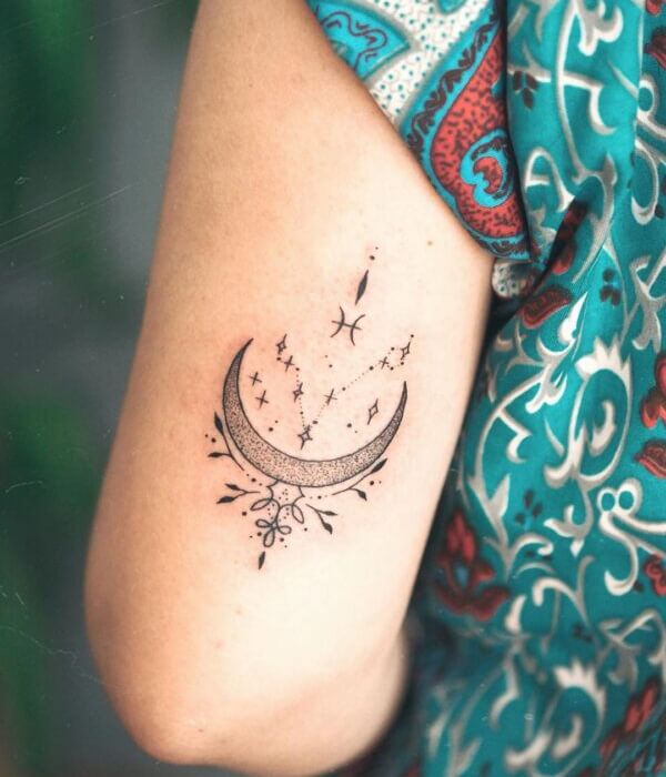 A minimalistic Pisces star and moon arm tattoo